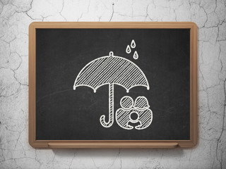 Protection concept: Family And Umbrella on chalkboard background