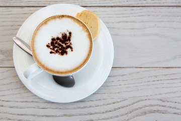  cappuccino coffee cup on wood table at coffee shop