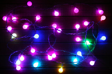 Electric Christmas garland on wooden background