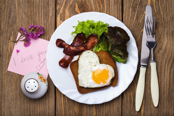 Scrambled eggs with sausage in a heart shape