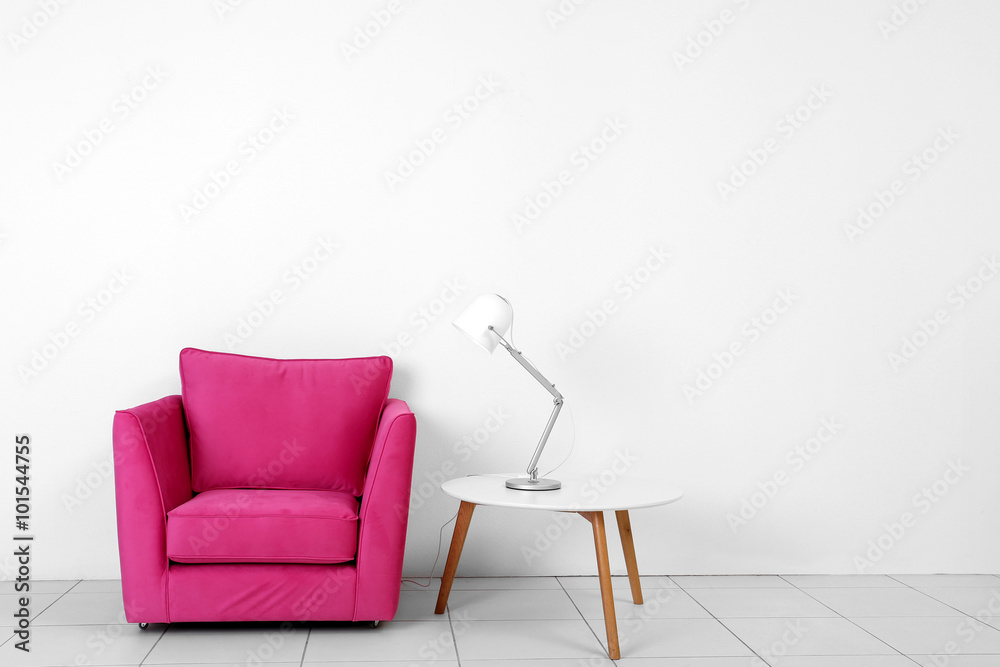 Wall mural living room interior with pink armchair, white table and lamp on white wall background