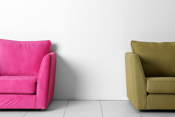Living room interior with pink and green armchairs on white wall background
