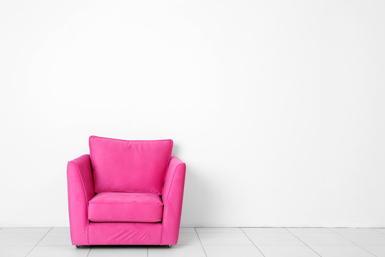 Living room interior with pink armchair on white wall background
