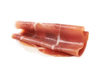 Folded prosciutto ham slice isolated