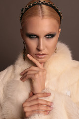 woman with blond hair and smokey eyes makeup,wears luxurious fur coat