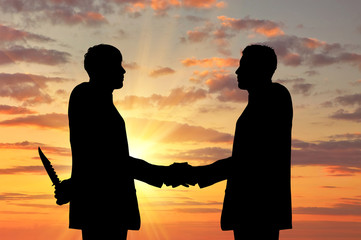 Silhouette of two businessmen shaking hands - obrazy, fototapety, plakaty
