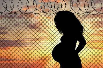 Silhouette of a pregnant refugee