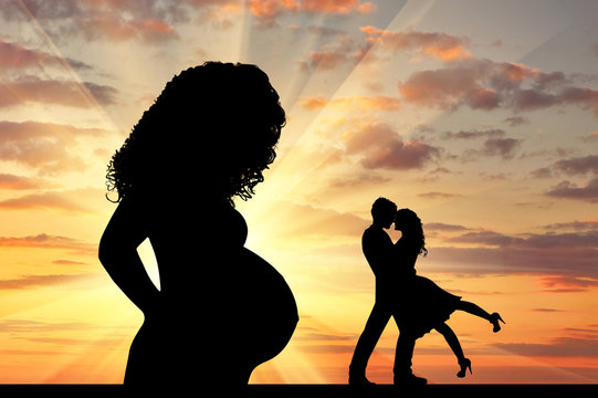 Silhouette a pregnant woman and  loving couple