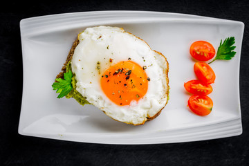 Sandwich with avocado paste and egg