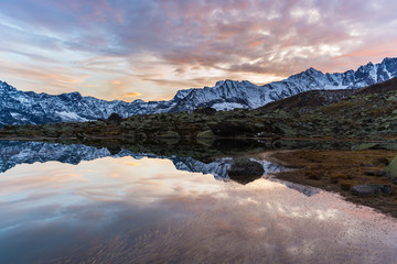 Obraz na płótnie Canvas High altitude alpine lake, reflections at sunset