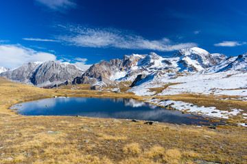 High altitude blue alpine lake in autumn season