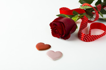 Rose, red ribbon and silk hearts