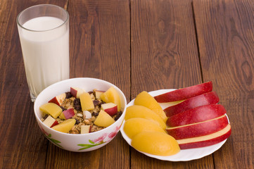 muesli with peach, apple and a glass of milk