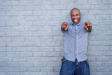 Cheerful young african man pointing finger
