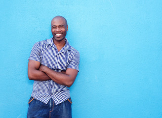 Handsome black man smiling with arms crossed