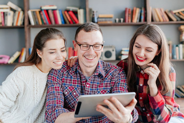 attractive couple using tablet together on futon h at home
