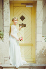 Fototapeta premium Beautiful bride with bouquet before wedding ceremony