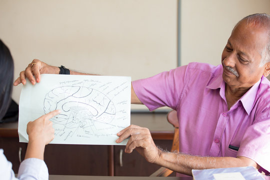 Closeup Portrait, Elderly In Pink Shirt Lecturer Explaining Anatomy To Health Students, Isolated Indoors Background