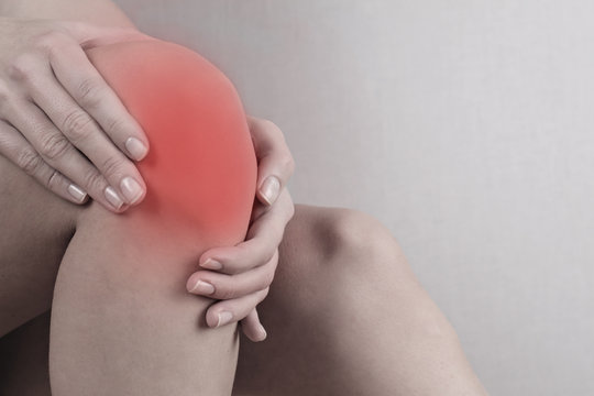 Woman with knee pain close up. Pain relief concept