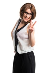 Fototapeta premium Brunette woman doing victory gesture