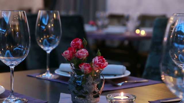 luxury restaurant table layout  with red roses for dinner being served 