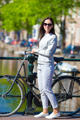 Fototapeta na wymiar Happy woman with bicycle on european vacation 