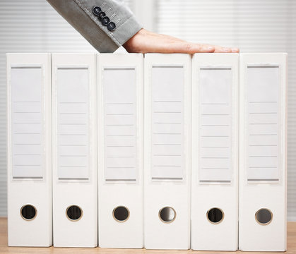 Businessman Holding Organized Documentation In Binders, Accounti