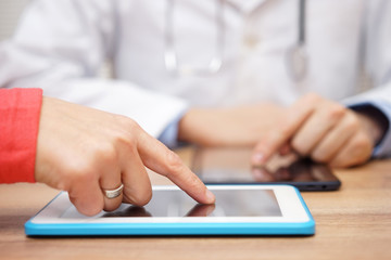 Fototapeta premium doctor is sending result of medical test to patient on tablet c