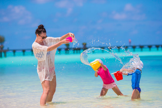 Happy Family Playing With Beach Toys On Tropical Vacation