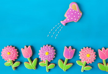 Homemade gingerbread cookies in the shape of flowers on wooden table
