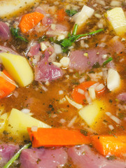 Beef stew in raw state inside pot at start of the cooking
