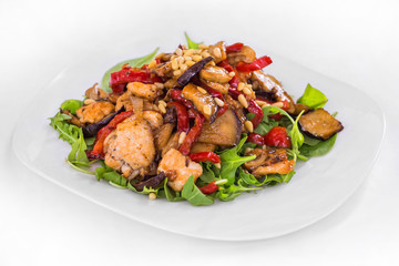 Chicken salad with fried eggplant, zucchini , haricot bean, sweet pepper and arugula. Isolated dish on a white background