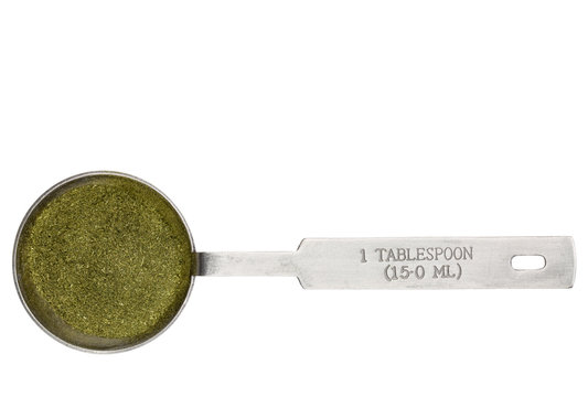 wheatgrass powder in a tablespoon