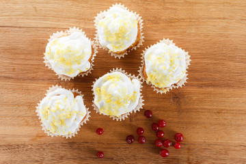 Cranberry muffins on wooden background.