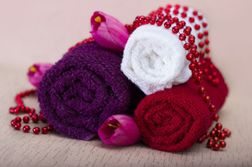 Fototapeta na wymiar White and red towel around beads and flowers