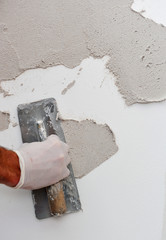 Applying plaster on the wall using a trowel
