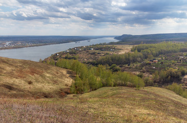 Fototapeta na wymiar Spring landscape in the hills on the bank of the river to the village. Kama River, the village Sentyak, Nizhnekamsk district Tatarstan