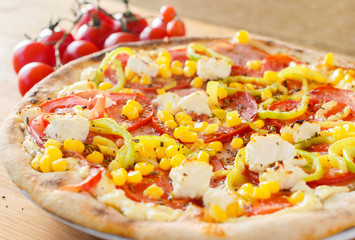 Pizza with vegetables, feta and ham