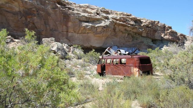 GREEN RIVER, UT - AUGUST 29, 2015: A rust covered van lies abandoned on the banks of the Green River in Southeastern Utah.