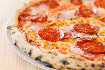 Pizza with sausage, bacon and pepperoni - close up