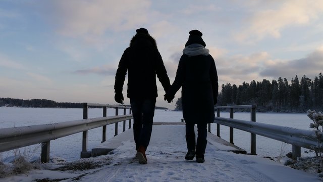 young couple walking together during winter holidays in scandinavia