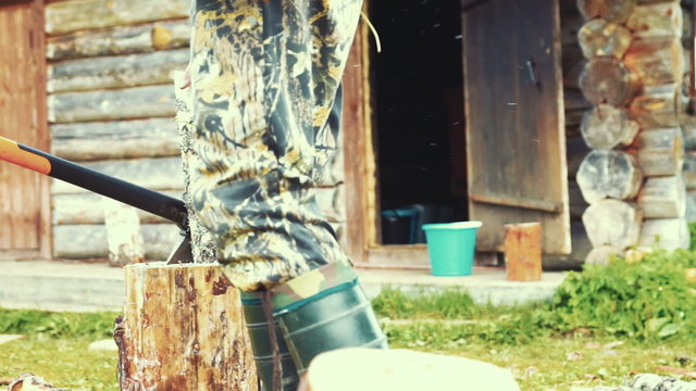 Man Chopping Wood Outdoors With Axe Cleaver