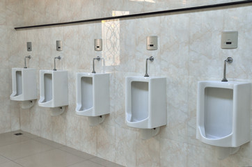 white porcelain urinals in public toilets