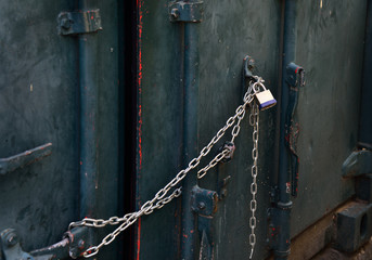 Closeup of a metal gate chained and locked