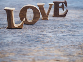 word "love" made of wood on wooden background