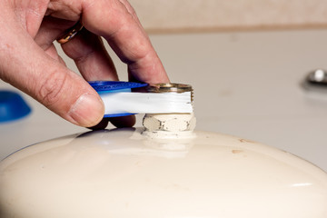 Wrapping teflon tape on a hot water heater