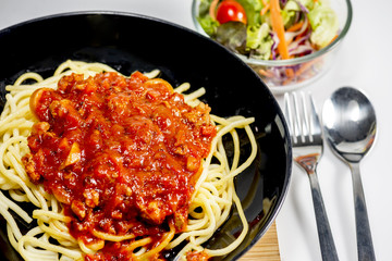 Spaghetti with tomato sauce and salad