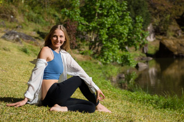 Smiling white young woman doing yoga