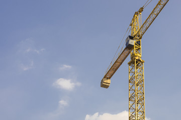 Naklejka premium construction cranes and the blue sky with clouds