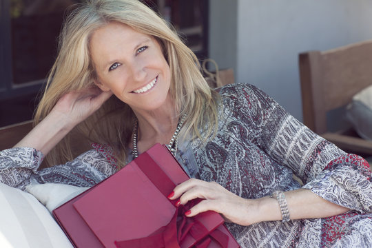 Happy Cute middle age woman with gift